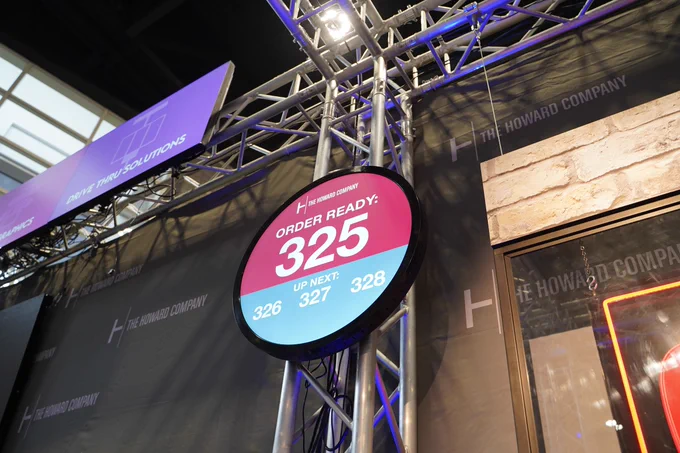 The Howard Company in house Order Ready pickup circle screen showing order 325 and up next numbers at NRA 2026
