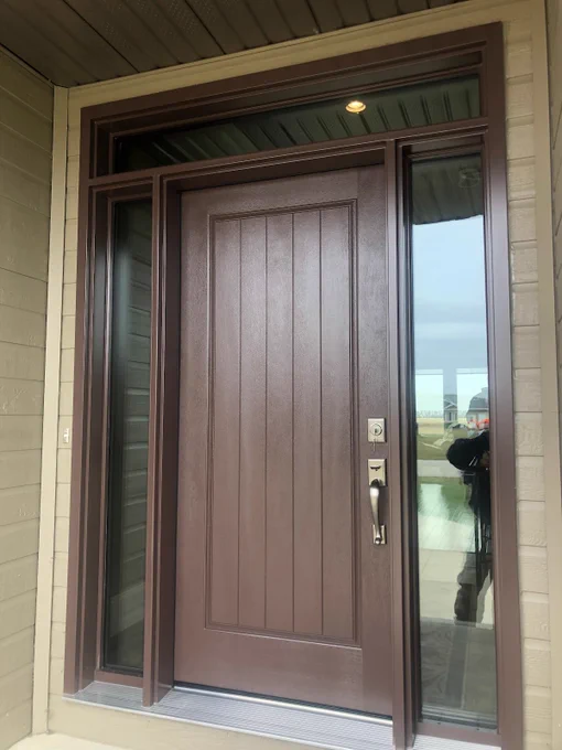 A modern custom-painted entry door with woodgrain finish and full-lite glass sidelights with a transom window above installed in Winnipeg home as energy-efficient replacement door system.
