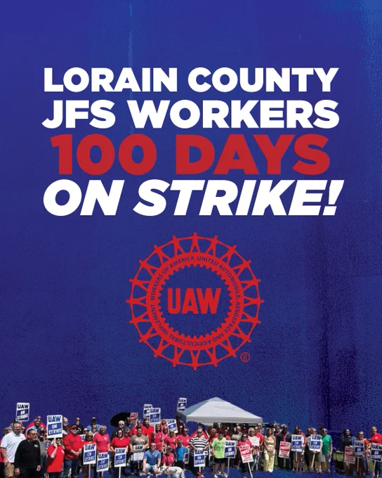 Lorain County JFS workers holding signs and gathered in a large group celebrating 100 days on strike with UAW logo above them.