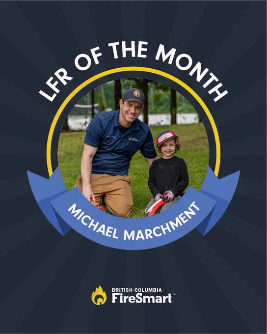 This image features a person wearing a uniform and a cap with an emblem, kneeling next to a child in outdoor clothing. They are smiling, and the child is holding a red object. The text above reads "LFR of the Month," and the name "Michael Marchment" is displayed. At the bottom, the logo for British Columbia FireSmart is shown.