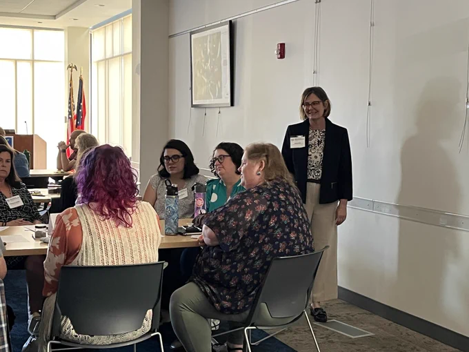 Tanya Vela, Accessible Ohio Specialist, talks with workshop participants during the Social Narrative workshop.