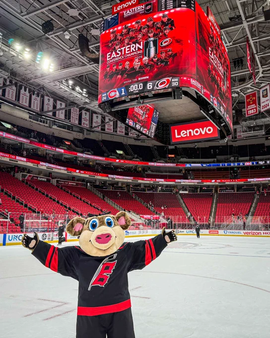Photo of Stormy posing with the video board displaying the Eastern Conference Champs graphic 