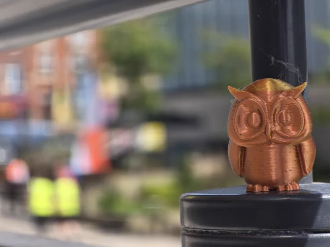 a 3d printed owl on a blurred background