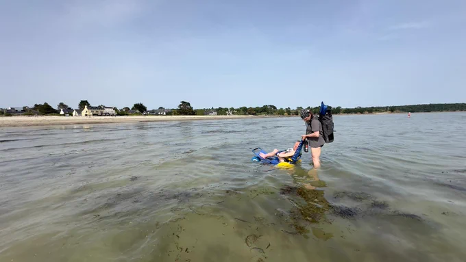 Ich im Strandrollstuhl im seichten Atlantik.