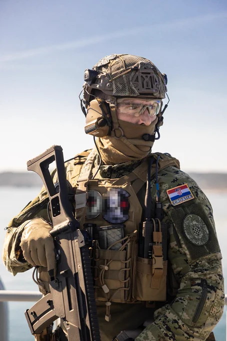 A Croatian soldier in combat gear holding a rifle.