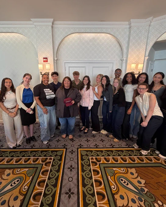 DCFNE team members Jess and Ryla pose with students from Riverdale Country School after their presentation.