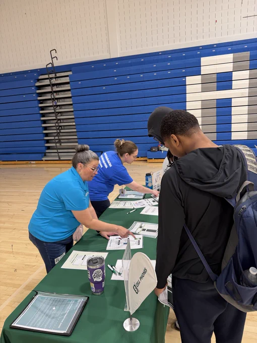students stopping at FMFCU reality fair table