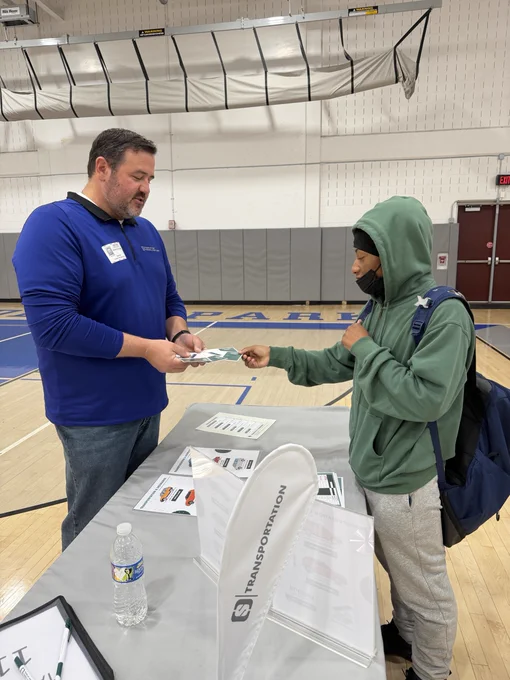 students stopping at FMFCU reality fair table