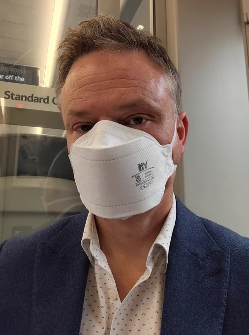 Man wearing FFP3 mask on a train.