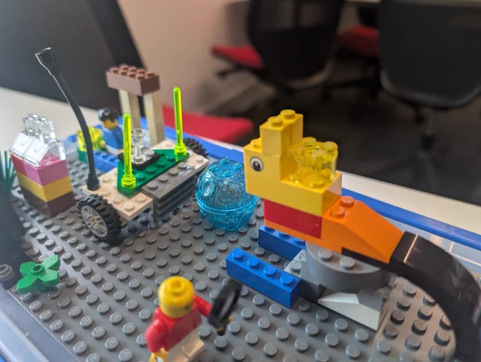A LEGO interpretation of an ideal pet situation - a cat with a light on its back to make it visible to cars, and its own robot vacuum cleaner to stop loose fur causing allergies.