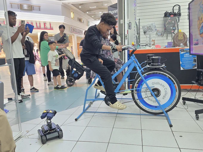 a small boy playing on a bike controlled video game
