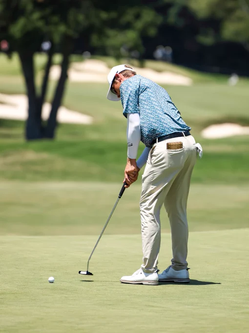Golfers compete during the UNC Health Championship, teeing off, hitting approach shots, and putting on the course