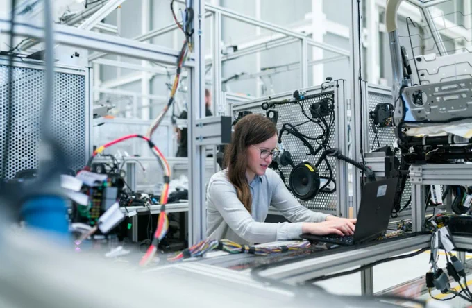Woman working on manufacturing tests. 
