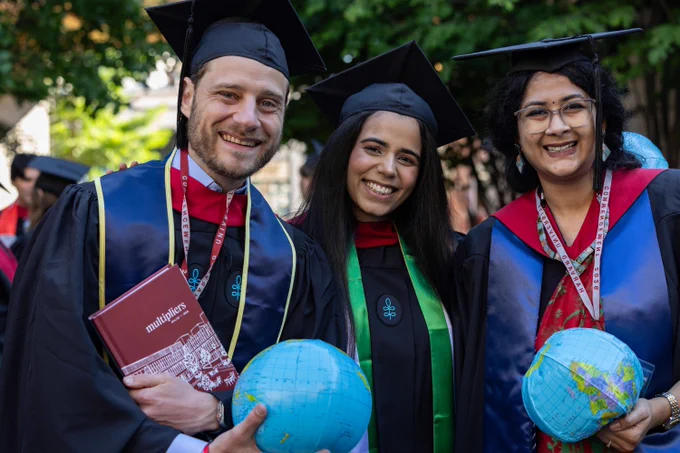 Three graduates posing for a photo.