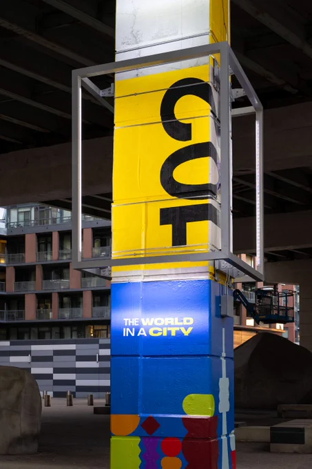 A new lighted sign with a market and the "World in a City" text.