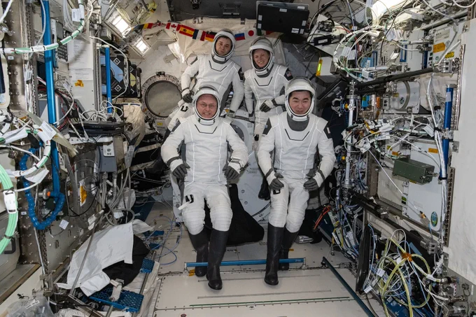 NASA’s SpaceX Crew-11 astronauts gather together for a crew portrait wearing their Dragon pressure suits during a suit verification check inside the International Space Station’s Kibo laboratory module. Clockwise from bottom left are, NASA astronaut Mike Fincke, Roscosmos cosmonaut Oleg Platonov, NASA astronaut Zena Cardman, and JAXA (Japan Aerospace Exploration Agency) astronaut Kimiya Yui.