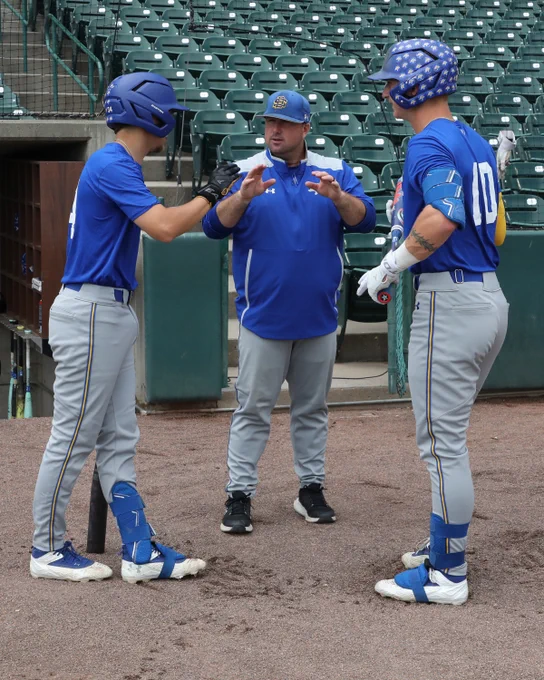 South Dakota State assistant coach Danny Higginbotham (center) discusses strategy with catchers Luke Evenson (left) and Nate Wachter (right) during batting practice leading up to the Jackrabbit baseball team's NCAA Regional game versus Arizona State on May 30, 2026, at Hawks Field in Lincoln, Nebraska.