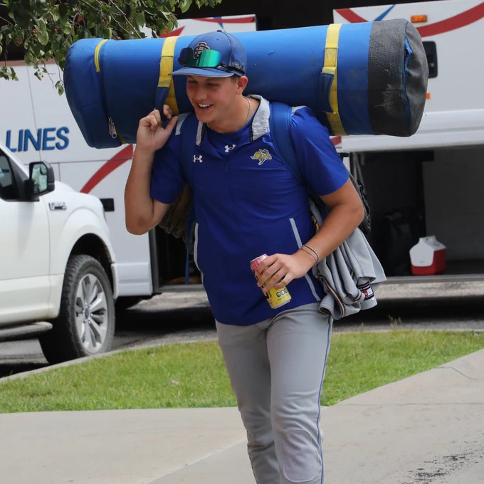 South Dakota State infielder Grant Sorensen hauls a bat bag from the team bus into Hawks Field prior to the Jackrabbits' NCAA Regional elimination game against Arizona State on May 30, 2026.