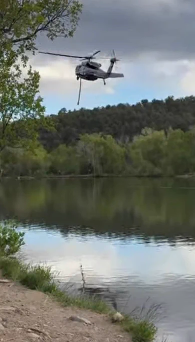 Helicopter dipping water out of Monastery Lake, located west of NM State Road 63
