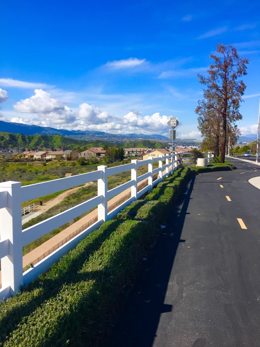 Bike Path in Santa Clarita with bright blue skies and puffy clouds in the distance. 