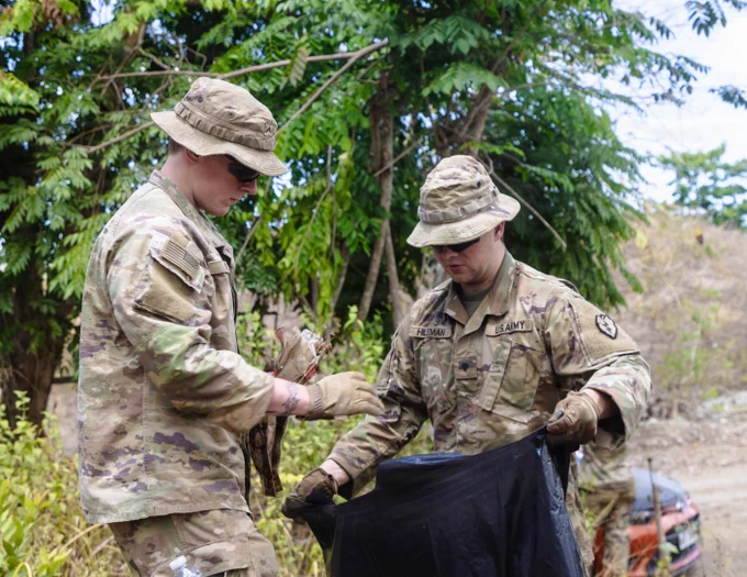U.S. Soldiers assigned to the 3rd Mobile Brigade, 25th Infantry Division, collect debris during a post-exercise cleanup effort as part of Joint Pacific Multinational Readiness Center Exportable Exercise at Laur, Philippines, May 21, 2026.