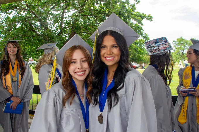 Two RSC graduates smile for a photo before the 2026 Commencement Ceremony.