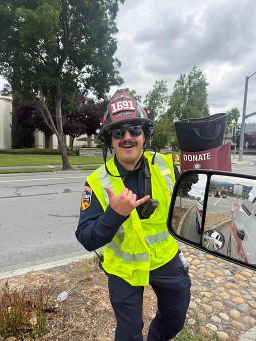 CAL FIRE Firefighter holding a boot during fundraiser