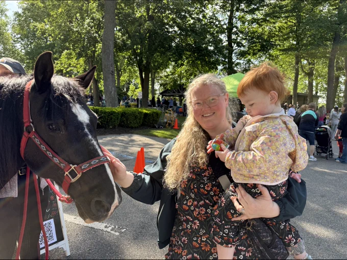 mom and child petting horse
