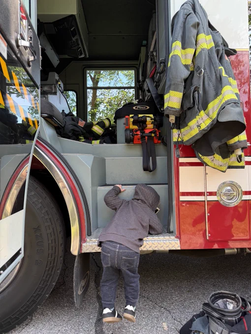 child climbing up into fire truck