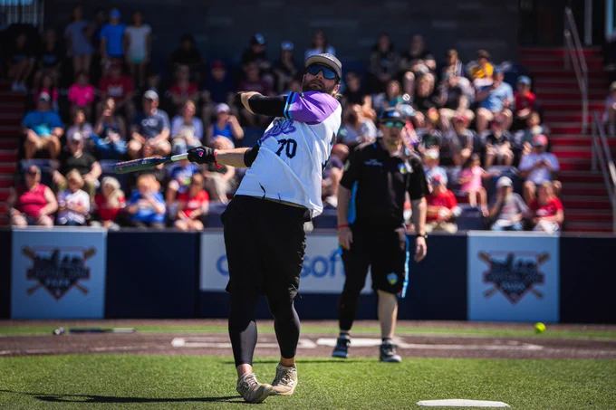 Braden Holtby swings for the fences during the charity softball game.