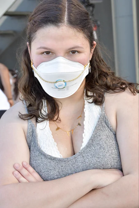 🆔 Emily, wearing a 3M Aura respirator, installed with a Sip Valve and a mask chain, posed for Julie Lam, founder of MaskTogetherAmerica, at a Positive Deviance “All Vinyl, All Love” rooftop party.