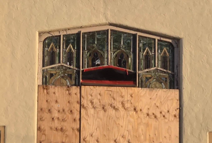 A close-up of the window. The tape resembles an open mouth and the panels above it look like cartoon eyes. If you use your imagination 