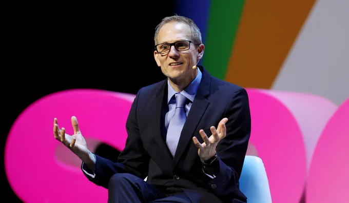 Dr J Simon Rofe in a suit on stage