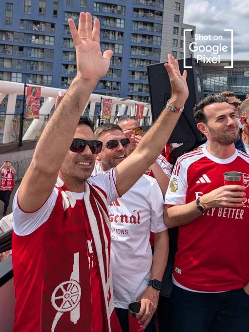Mikel Arteta waving to the Arsenal supporters on the Champions bus 