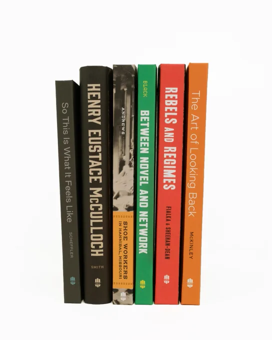 Six upright books against a white background.