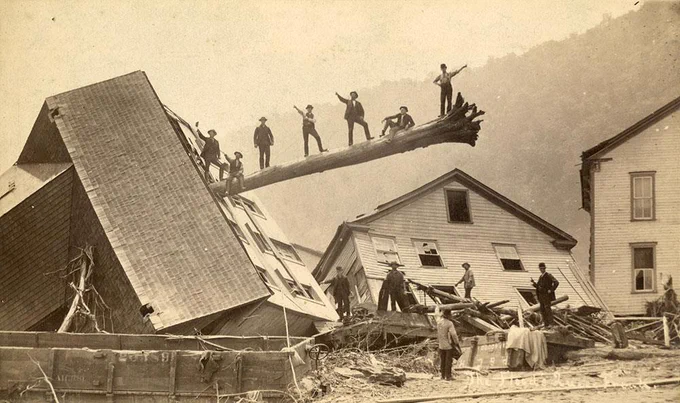These men are posing on an uprooted tree that impaled the second floor of an overturned building. This remarkable devastation was caused by the May 31, 1889 Johnstown Flood.

This photo is preserved by the Pennsylvania State Archives.
