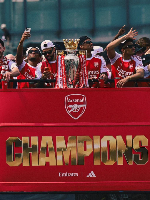 Arsenal squad with the Premier League trophy on the Champions bus