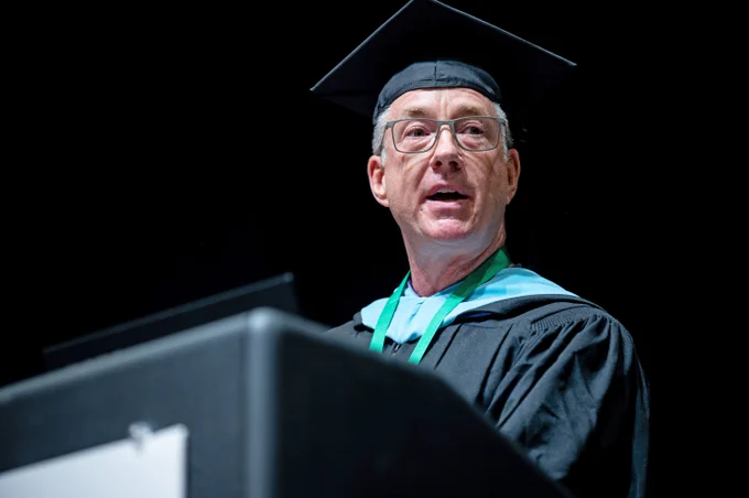 Jon Longest speaks from the podium during Commencement.