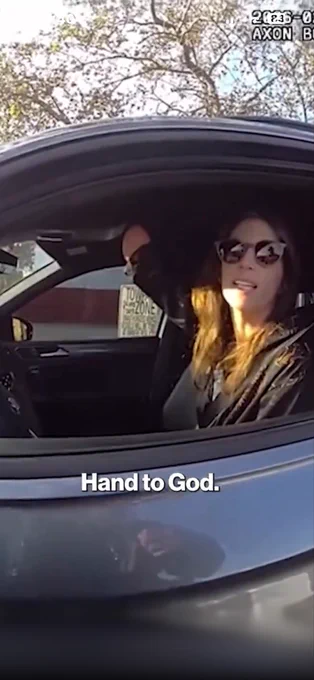 A woman raising her right stump to swear to an officer who accused her of using a right hand she didn't have to hold her phone while driving. Caption: Hand to God. 