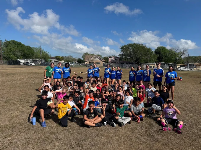 Texas A&M-Corpus Christi soccer team with elementary schoolers
