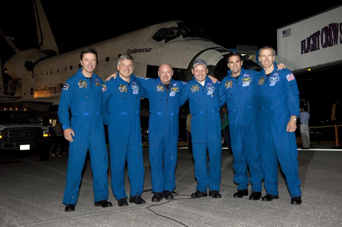 In this photo of the STS-134 crew are (left to right) ESA astronaut Roberto Vittori, mission specialist; NASA astronauts Greg H. Johnson, pilot; Mark Kelly, commander; Michael Fincke, Greg Chamitoff and Andrew Feustel, all mission specialists. Behind them is Space Shuttle Endeavour.