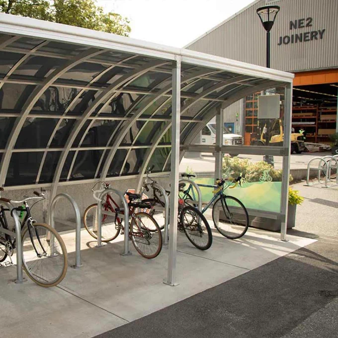 Bike storage area at BCIT campus with several bicycles parked under a covered structure. 