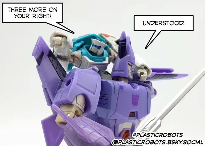 Tailgate, piggybacking on Cyclonus' back, informs him that three more enemies are on the latter's right to which Cyclonus acknowledges the heads-up. 