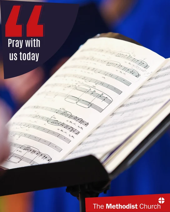 Photo of a sheet music open on a stand. Methodist logo in the lower right corner and text which reads 'pray with us today' in the upper left. 