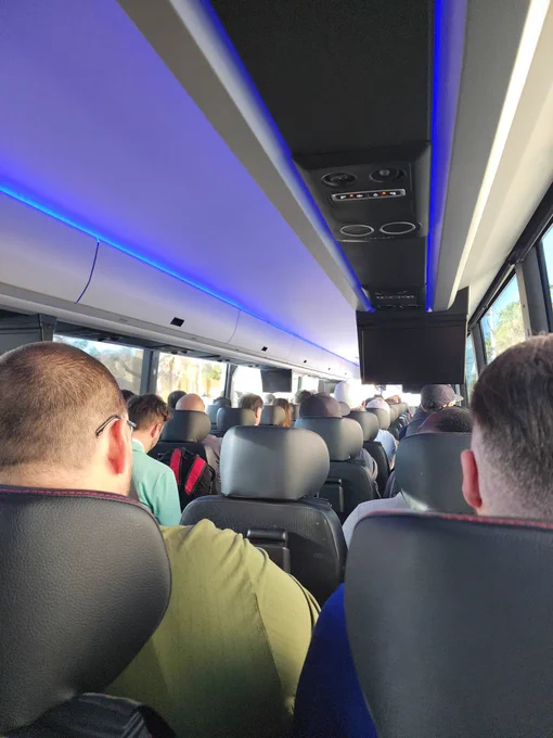 A bunch of geeks on a bus.