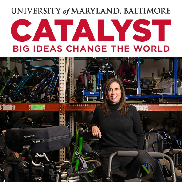 Debbie Sahlin standing in a workshop filled with wheelchairs and mobility equipment, representing innovation at University of Maryland, Baltimore Catalyst program.
