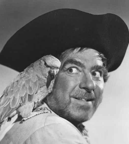 Robert Newton, WWII Royal Navy veteran and the man who gave the word pirate voices - with a West Country twang! He is seen dressed as a pirate complete with a parrot! Born in Dorset, ashes scattered in Mounts Bay, Cornwall.