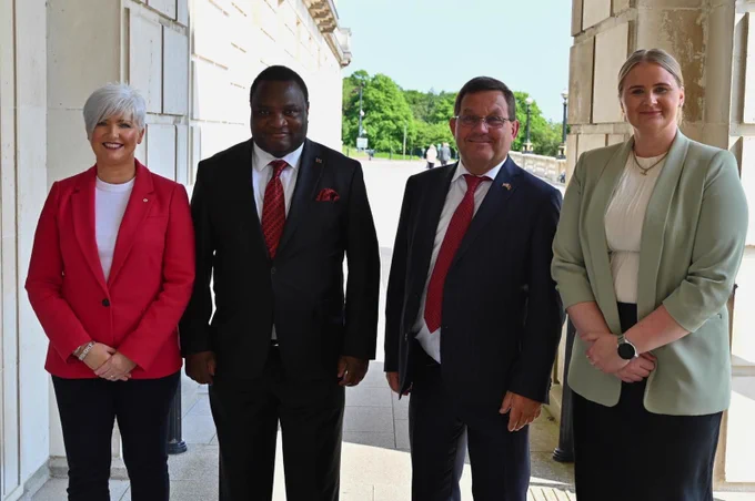 Image of four people standing outside Parliament Buildings – Junior Minister Joanne Bunting, Malawi’s High Commissioner to the UK, His Excellency Dr Thomas John Bisika, Honorary Consul for Malawi, Carson McMullan, and Junior Minister Aisling Reilly.