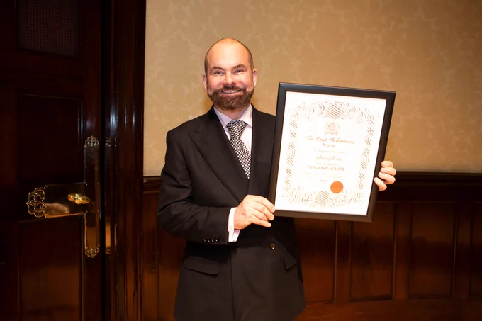 RPS Honorary Member and former Chair John Gilhooly with his Honorary Membership certificate, on stage at Wigmore Hall. 
