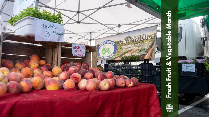 A farmer's market stall displays baskets of peaches with a handwritten sign reading "Herb's 3 for $2." A banner shows "P & A Produce" with a logo. In the background, a truck and other fruits and vegetables can be seen. A vertical green banner reads "Fresh Fruit & Vegetable Month" with USDA AMS logos.